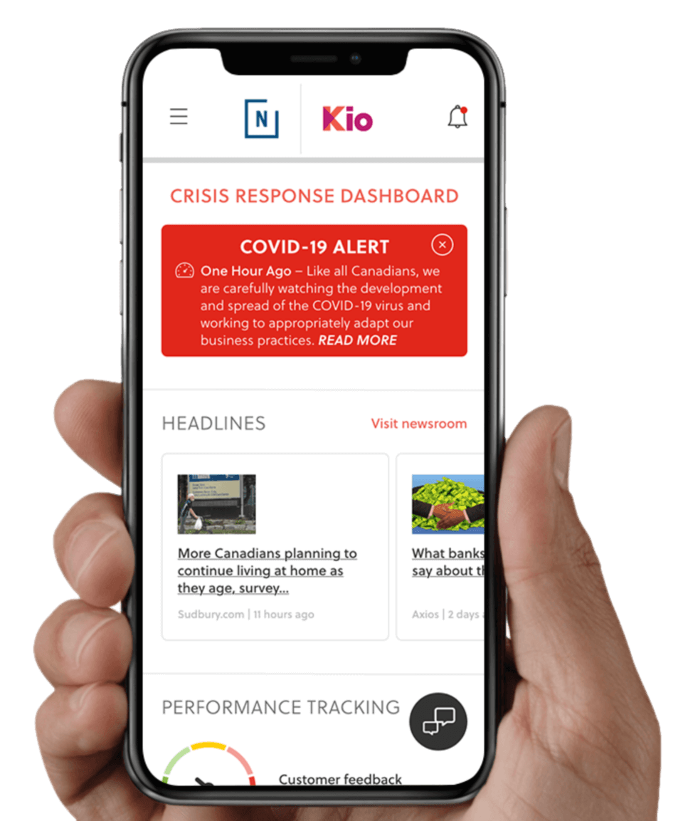 Hand holding a cellphone with Kio by Navigator crisis communications dashboard